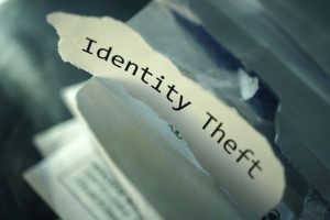 Image of a piece of shredded paper that says "Identity Theft"